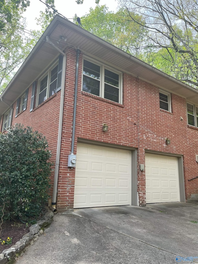 6818 Criner Rd SE, Huntsville, AL 35802 - view of home's exterior with an attached garage, driveway, and brick siding