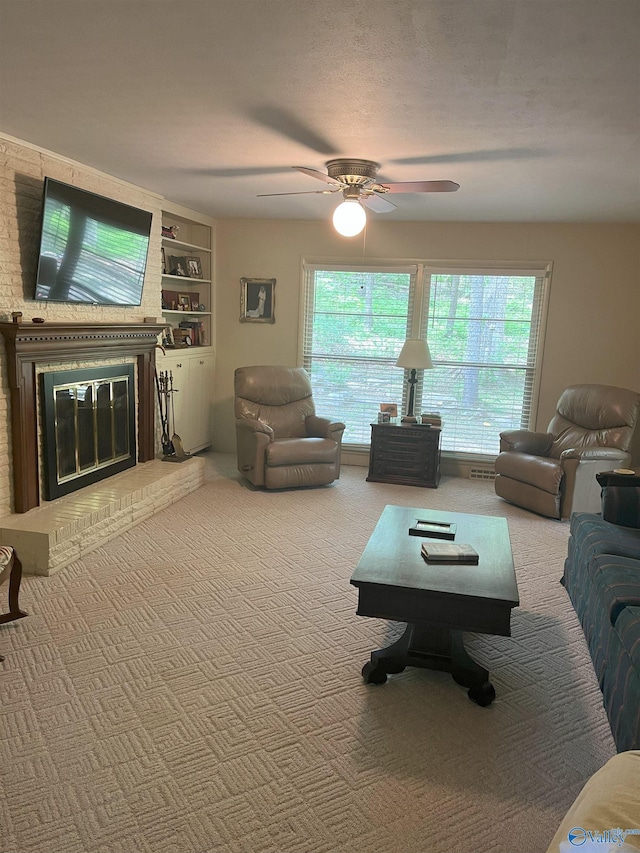 6818 Criner Rd SE, Huntsville, AL 35802 - carpeted living room with plenty of natural light, a ceiling fan, a fireplace, and built in shelves