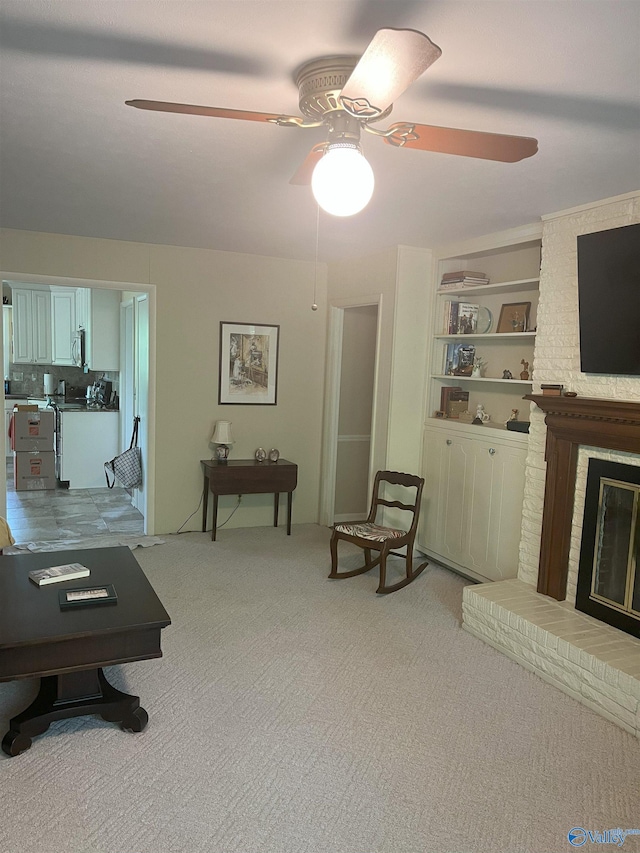 6818 Criner Rd SE, Huntsville, AL 35802 - living room featuring a ceiling fan, light carpet, a brick fireplace, and built in shelves