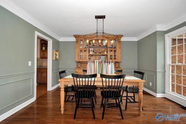 2616 Bransford Trl SE, Owens Cross Roads, AL 35763 - dining room with crown molding, a wainscoted wall, an inviting chandelier, and dark wood-style floors