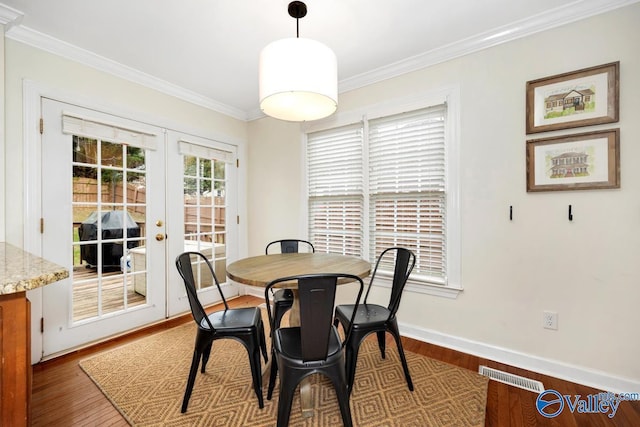 2616 Bransford Trl SE, Owens Cross Roads, AL 35763 - dining space featuring visible vents, baseboards, ornamental molding, wood finished floors, and french doors