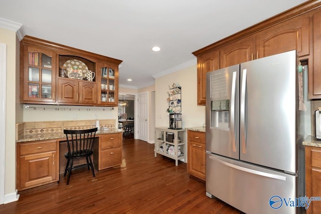 2616 Bransford Trl SE, Owens Cross Roads, AL 35763 - kitchen featuring crown molding, stainless steel fridge with ice dispenser, glass insert cabinets, brown cabinetry, and dark wood-style flooring