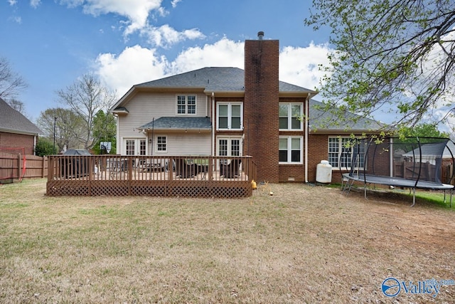 2616 Bransford Trl SE, Owens Cross Roads, AL 35763 - rear view of house featuring a wooden deck, a yard, a chimney, fence, and a trampoline