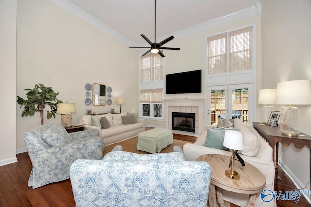 2616 Bransford Trl SE, Owens Cross Roads, AL 35763 - living room featuring ornamental molding, a tile fireplace, a high ceiling, and wood finished floors