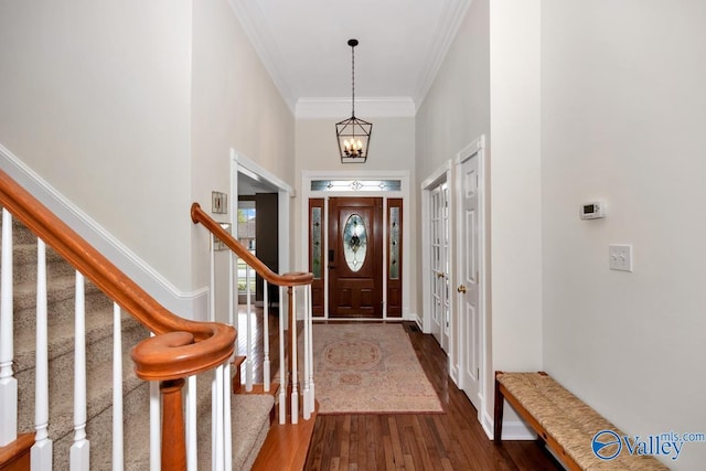 2616 Bransford Trl SE, Owens Cross Roads, AL 35763 - entrance foyer with crown molding, dark wood-type flooring, stairway, a chandelier, and baseboards