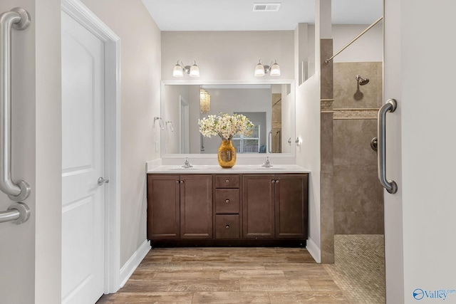 158 Kenton Ln, Madison, AL 35756 - full bath with a sink, visible vents, tiled shower, and wood finished floors