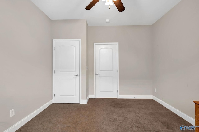 158 Kenton Ln, Madison, AL 35756 - unfurnished bedroom with ceiling fan, dark colored carpet, and baseboards