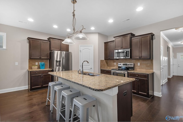 158 Kenton Ln, Madison, AL 35756 - kitchen with dark brown cabinetry, visible vents, dark wood finished floors, stainless steel appliances, and a sink