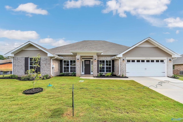 view of front of home featuring a front yard and a garage