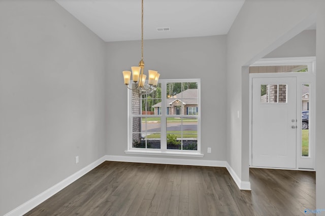 entryway with a notable chandelier and dark wood-type flooring