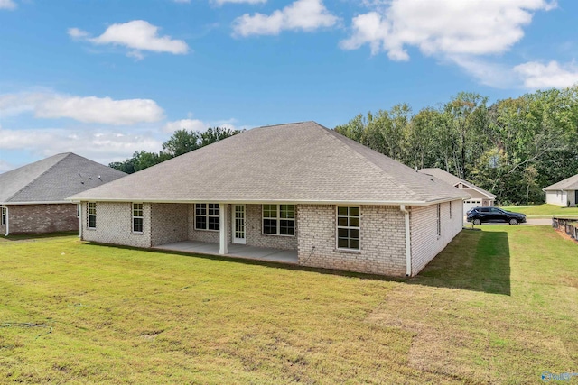 rear view of house featuring a patio and a lawn