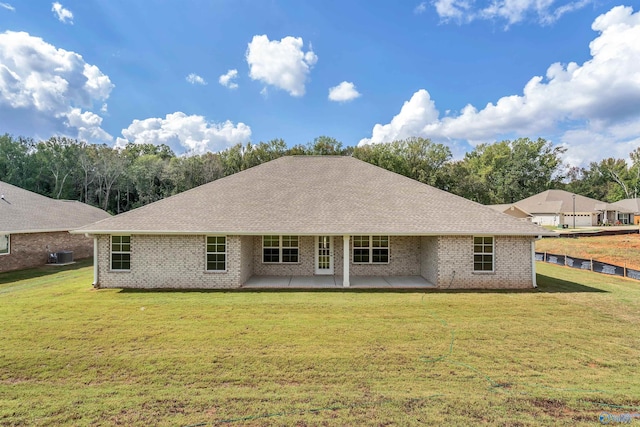 rear view of property with a yard and a patio area