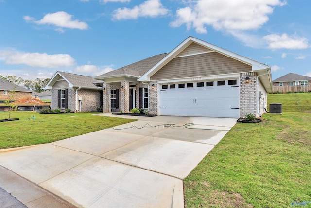 view of front of house featuring a front yard, central AC, and a garage