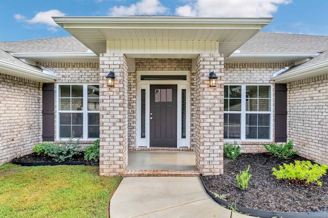 entrance to property featuring a lawn