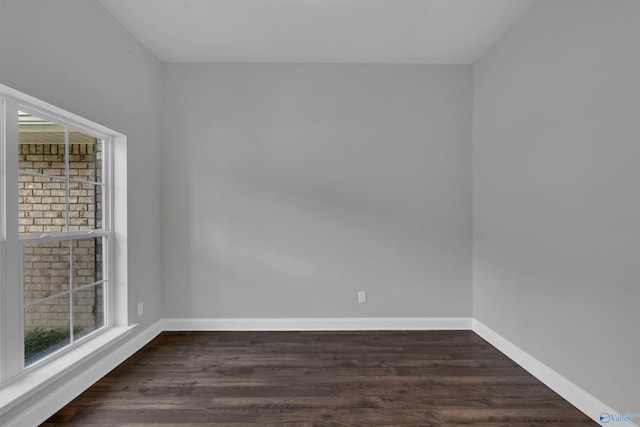 unfurnished room with dark hardwood / wood-style floors