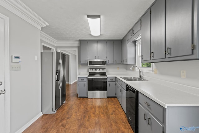 kitchen featuring ornamental molding, gray cabinets, appliances with stainless steel finishes, and sink