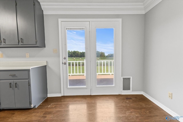 entryway featuring ornamental molding and dark hardwood / wood-style flooring