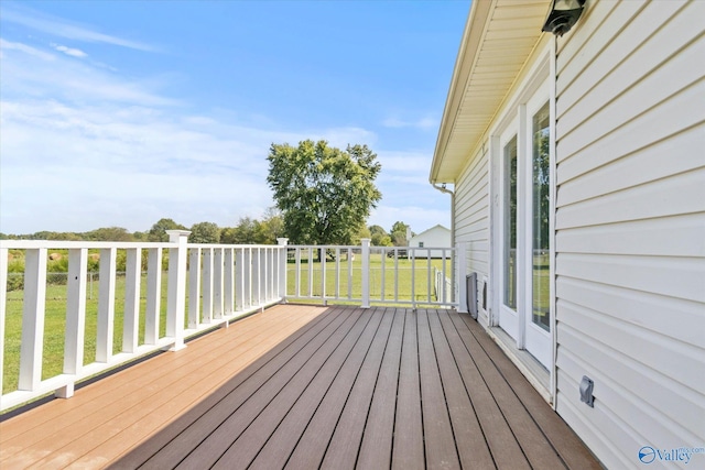 wooden terrace with a lawn