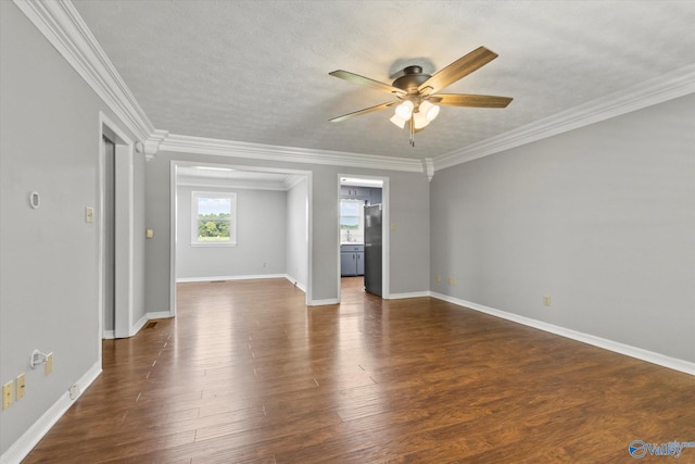 spare room featuring a textured ceiling, crown molding, dark hardwood / wood-style floors, and ceiling fan