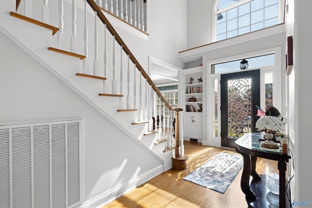 2907 Madrey Ln, Hampton Cove, AL 35763 - entrance foyer featuring baseboards, wood finished floors, a towering ceiling, visible vents, and stairway
