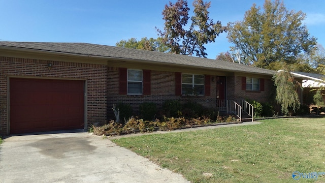 ranch-style house with a front lawn, concrete driveway, brick siding, and an attached garage