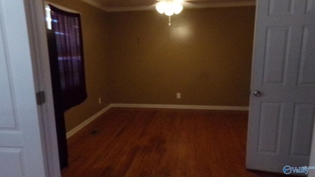 empty room with a ceiling fan, baseboards, and wood finished floors