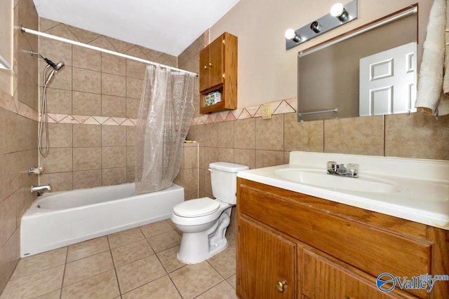 full bathroom with toilet, vanity, shower / bath combo, tile patterned flooring, and tile walls