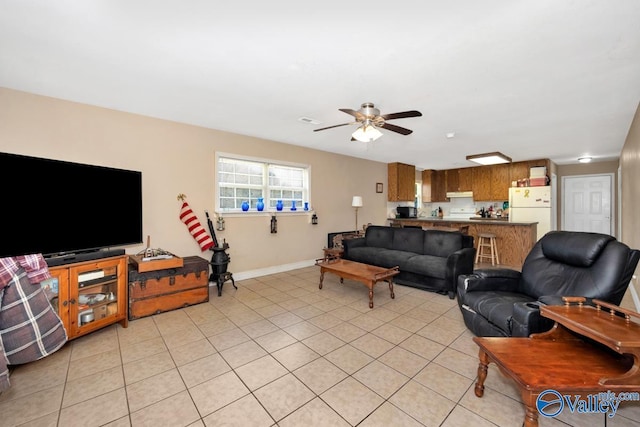 living area with a ceiling fan, light tile patterned flooring, baseboards, and visible vents