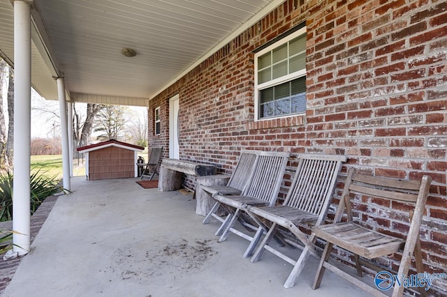 view of patio featuring an outdoor structure and a shed
