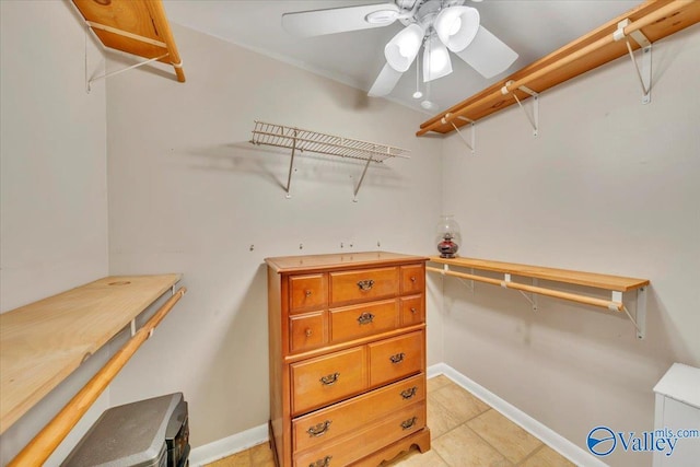 spacious closet featuring light tile patterned floors and a ceiling fan