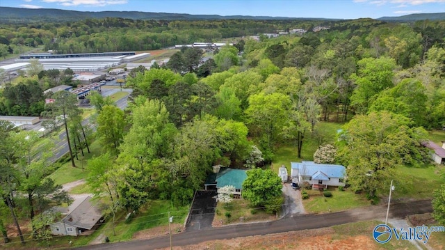 drone / aerial view featuring a wooded view
