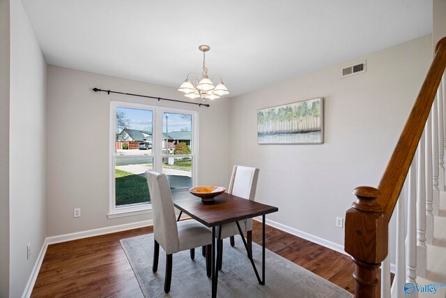 dining space featuring dark wood-style floors, visible vents, stairway, and baseboards