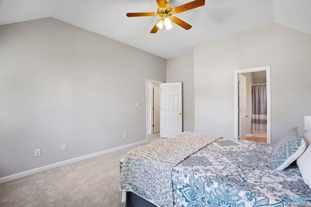 carpeted bedroom with vaulted ceiling, a ceiling fan, baseboards, and connected bathroom