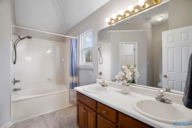 full bathroom with vaulted ceiling, toilet, shower / tub combo with curtain, and a sink