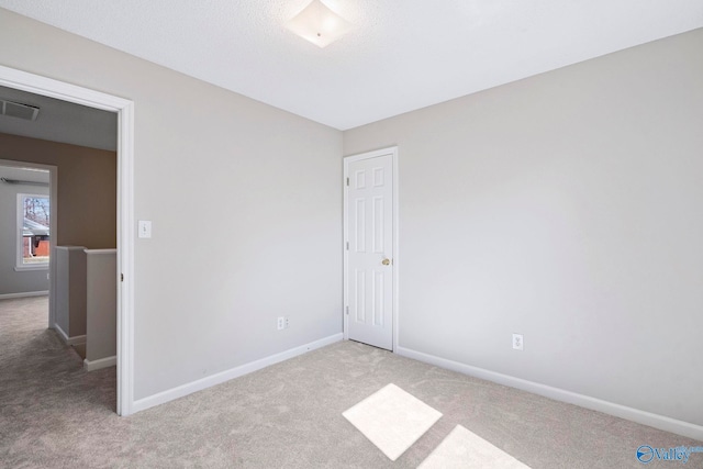 unfurnished bedroom featuring visible vents, baseboards, and carpet