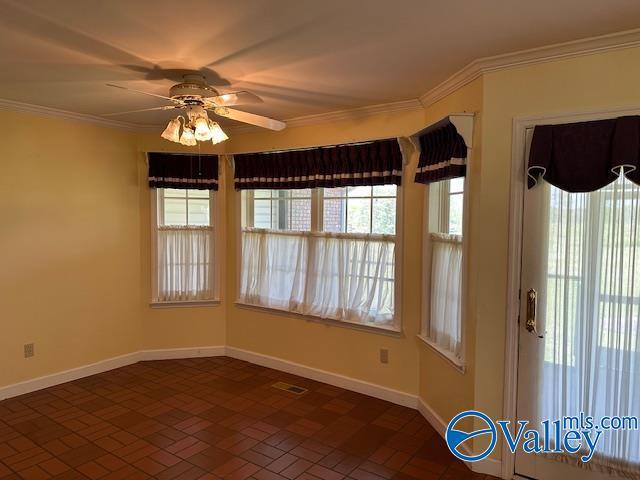 interior space featuring a ceiling fan, baseboards, and a healthy amount of sunlight