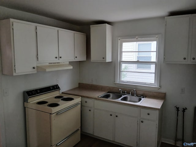 kitchen featuring sink, electric range, and white cabinetry