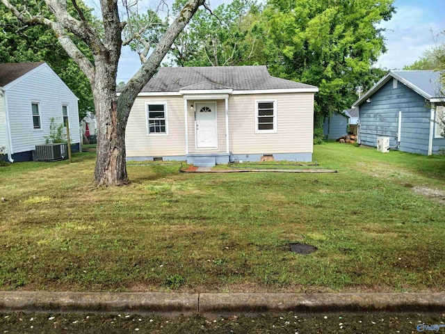 view of front of home with central AC and a front lawn