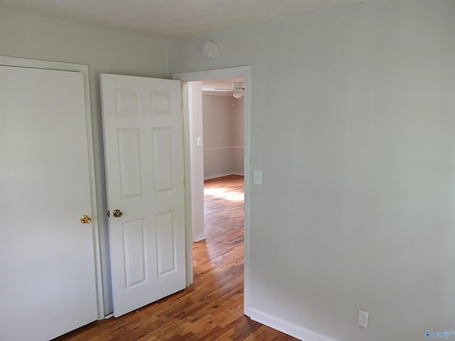 hall with hardwood / wood-style flooring