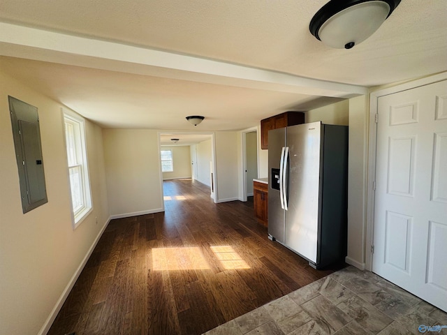 corridor featuring dark hardwood / wood-style flooring and electric panel