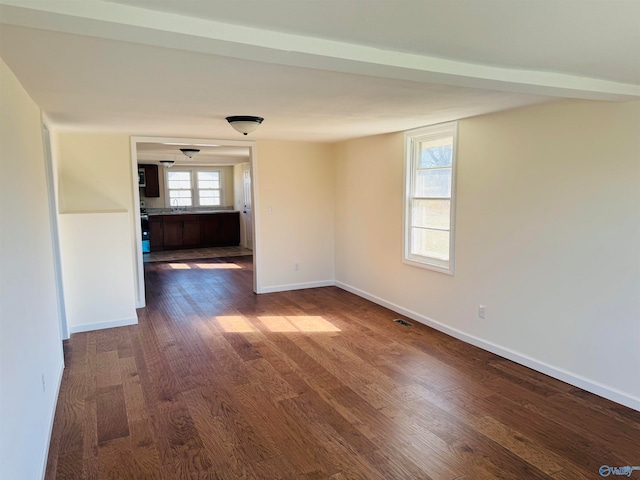 spare room featuring dark wood-type flooring