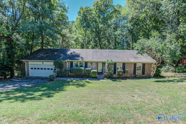 ranch-style home featuring a garage and a front yard