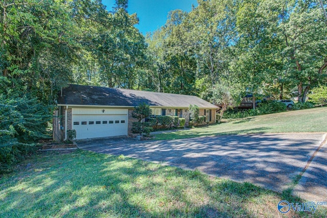 ranch-style home featuring a front lawn and a garage