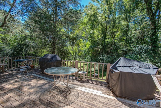 wooden terrace with a grill