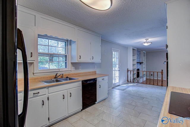 kitchen with fridge, white cabinetry, dishwasher, and sink