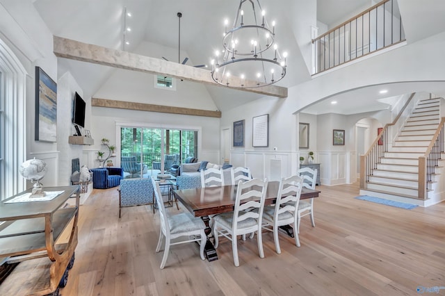 13559 Monte Vedra Rd SE, Huntsville, AL 35803 - dining space featuring high vaulted ceiling, arched walkways, light wood-style floors, a decorative wall, and stairway