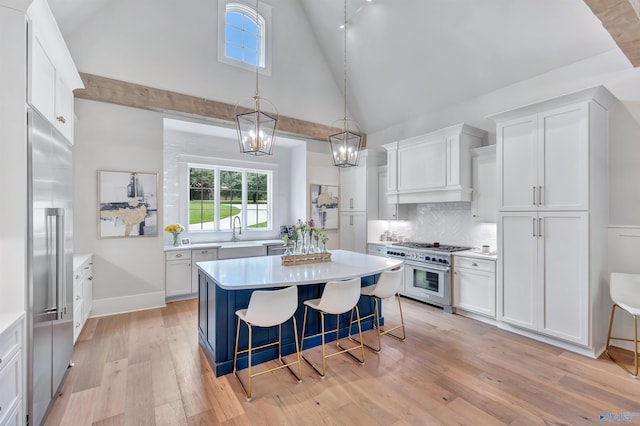 13559 Monte Vedra Rd SE, Huntsville, AL 35803 - kitchen with high quality appliances, white cabinets, light countertops, and high vaulted ceiling