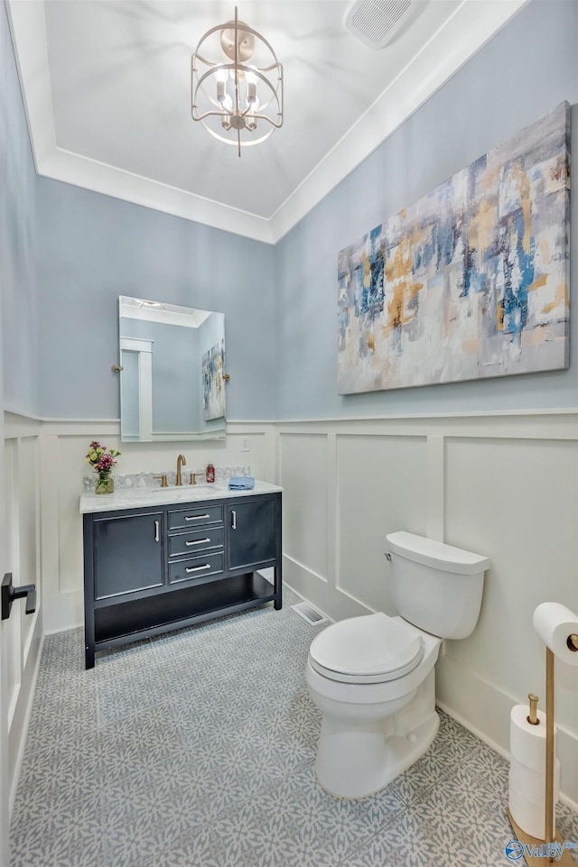13559 Monte Vedra Rd SE, Huntsville, AL 35803 - bathroom with a decorative wall, vanity, a wainscoted wall, a chandelier, and ornamental molding