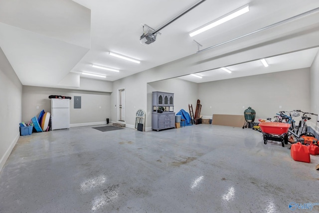13559 Monte Vedra Rd SE, Huntsville, AL 35803 - garage featuring electric panel, a garage door opener, and freestanding refrigerator