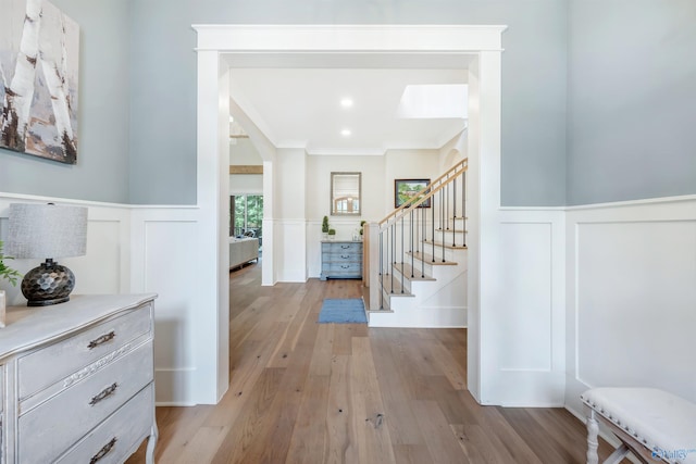 13559 Monte Vedra Rd SE, Huntsville, AL 35803 - foyer featuring a decorative wall, stairway, light wood-style flooring, a wainscoted wall, and crown molding